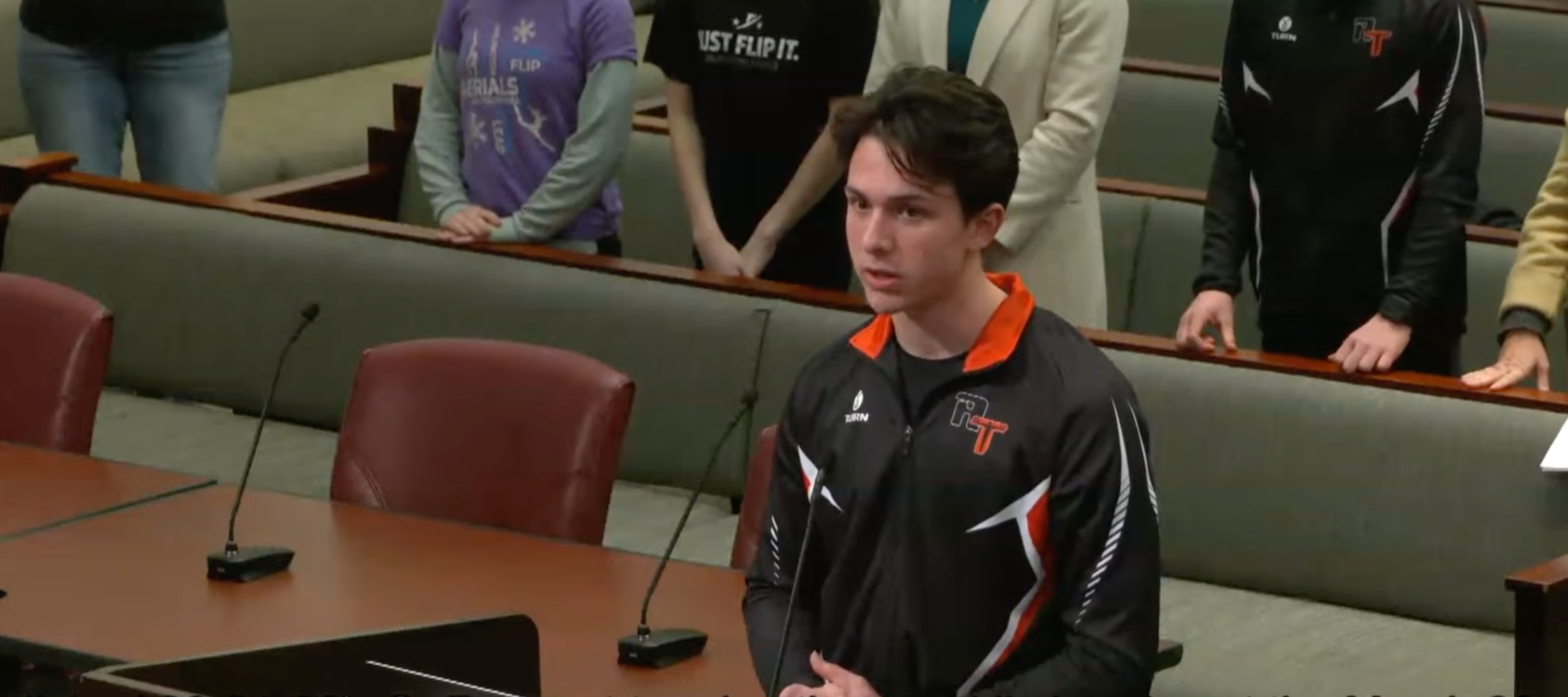 Rocco Giambalvo at podium in Tigers jacket