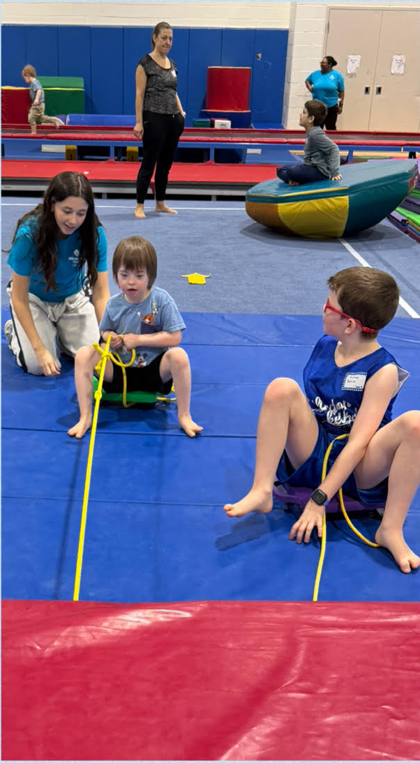 Gabriel doing a floor exercise with Barcroft staff